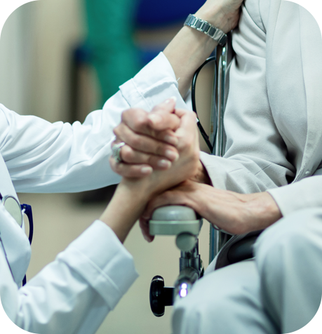 A male patient who is assisted by a nurse.